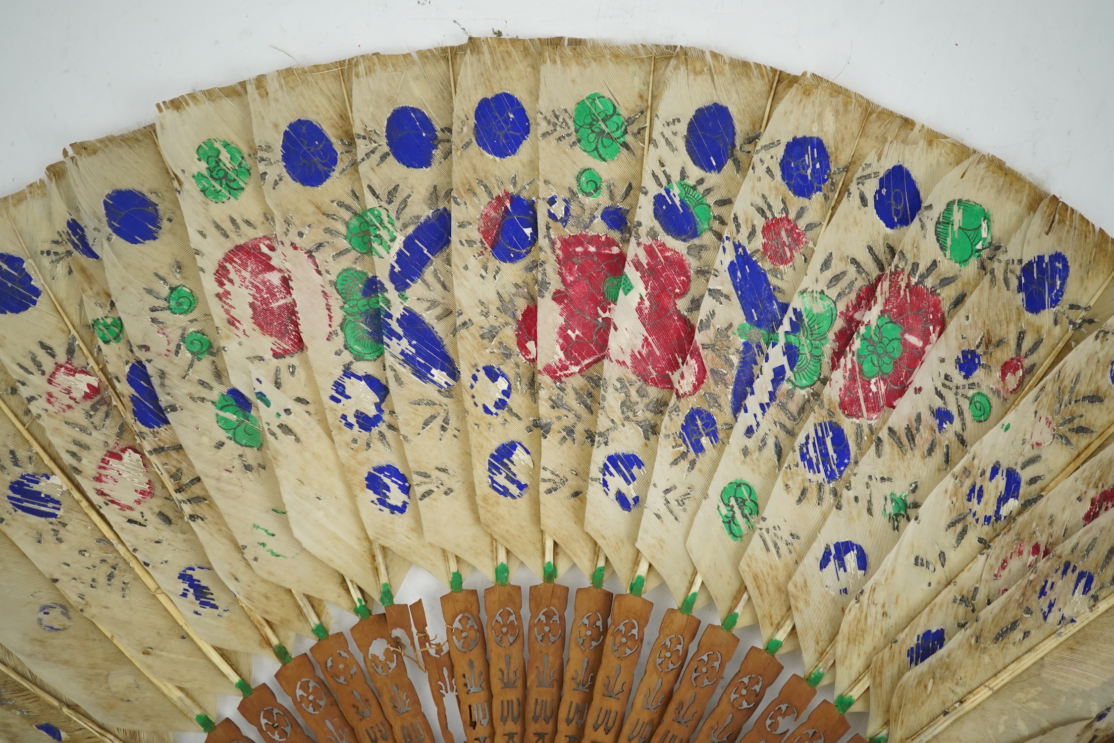 Three 19th century Chinese feather fans: One a carved bone brise black feather fan together with two similar carved sandalwood feather fans, two fans have hand painted decoration on the feathers both sides, the pink feat